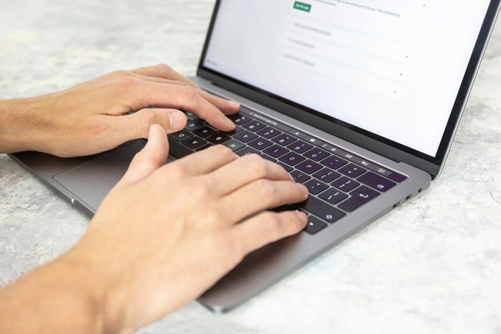 A person typing on a laptop