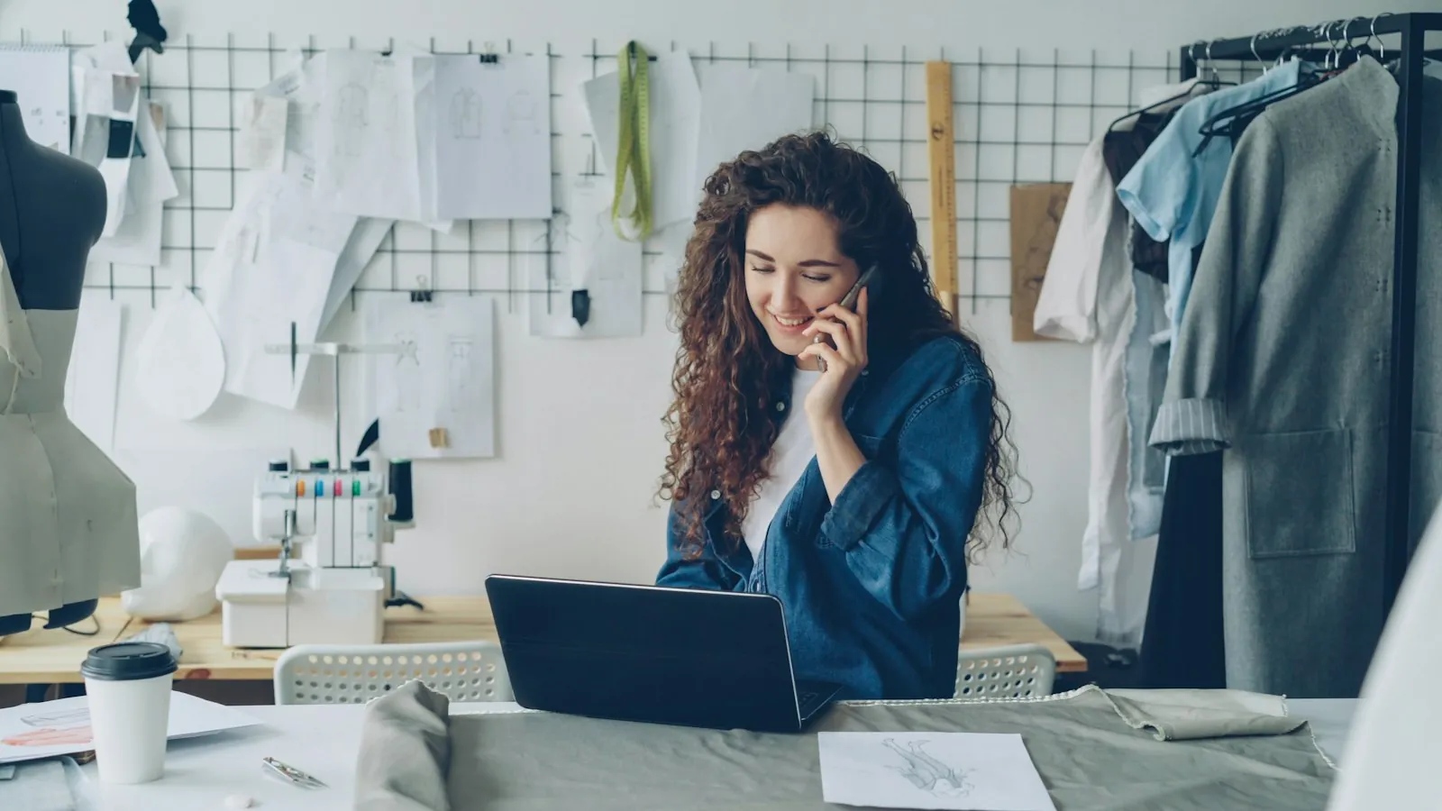 Busy business owner on the phone while working on a laptop
