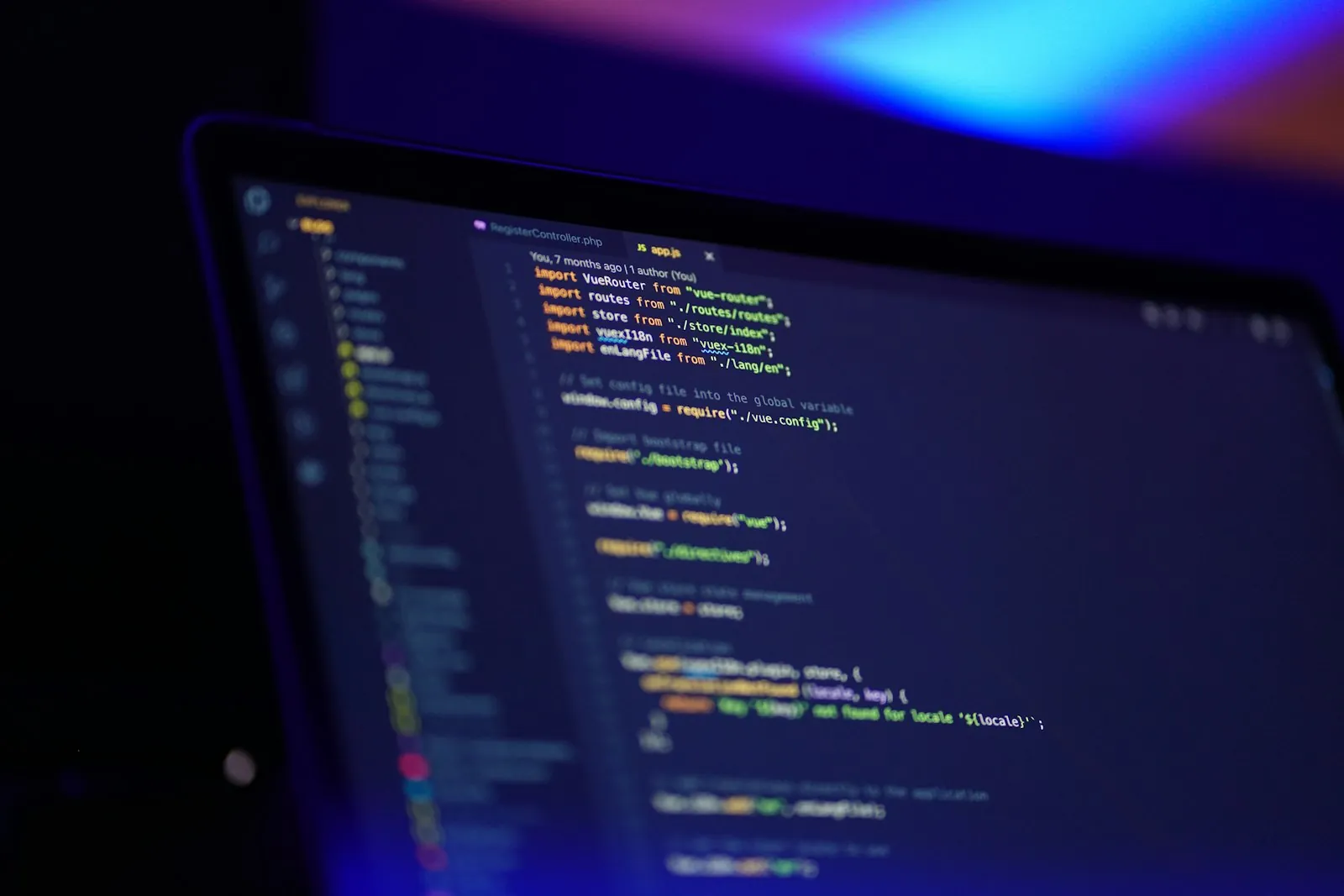 A laptop screen showing colourful website code