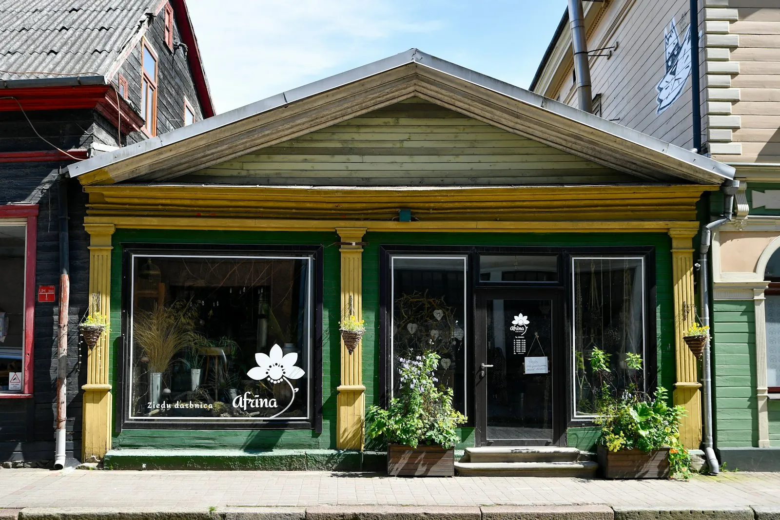 Small local storefront with yellow and green trim