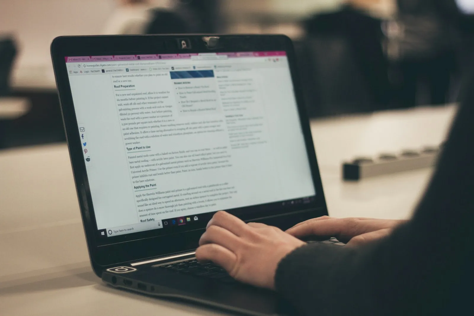 A person typing a message on a laptop